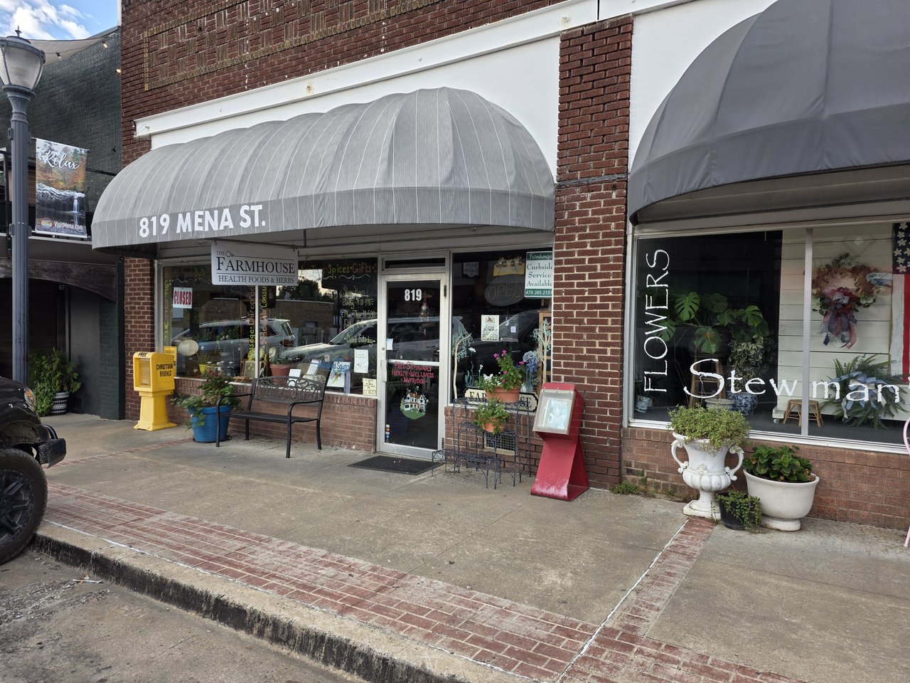 Storefront at 819 Mena Street with a gray awning and glass entrance.